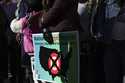 A community member holds a sign calling for a national boycott of Target stores during a news confe…