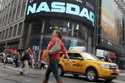 Commuters traverse New York's Times Square in front of the Nasdaq MarketSite, Wednesday, May 16, 20…