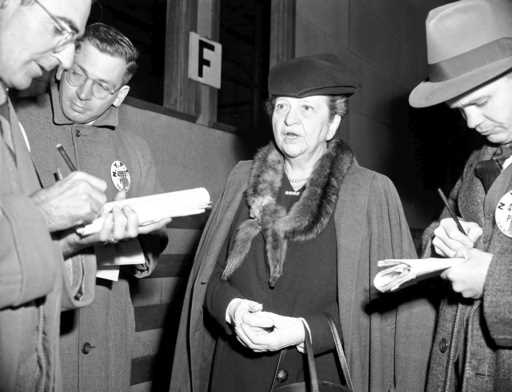 Former Secretary of Labor Frances Perkins chats with reporters in New York, November 27, 1945, as s…