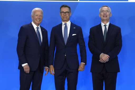 President Joe Biden, left, and NATO Secretary General Jens Stoltenberg, right, greet Alexander Stub…