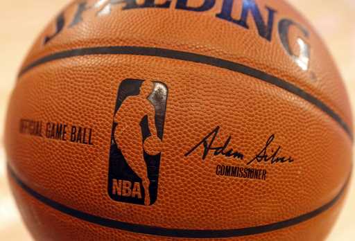 An NBA logo is seen on an official game ball before a basketball game, February 1, 2014, in New Yor…