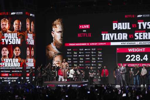 Mike Tyson steps on the scale during a weigh-in ahead of his heavyweight bout against Jake Paul, in…