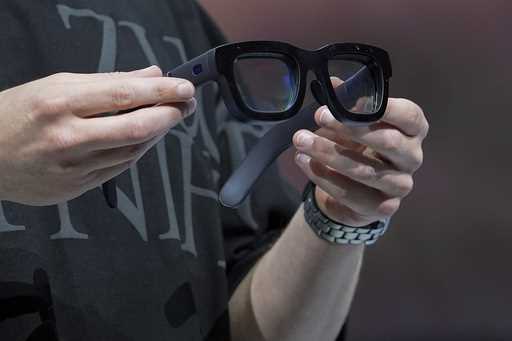 Mark Zuckerberg holds a pair of Orion AR glasses during the Meta Connect conference, on Sept