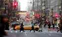 Vehicles and pedestrians make their way down Fifth Avenue in New York, December 22, 2005, 