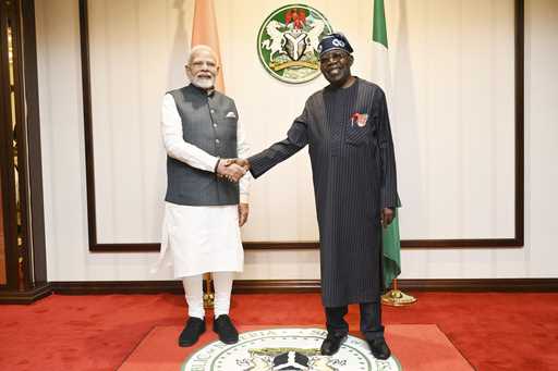 Nigeria's President, Bola Ahmed Tinubu, right, welcomes Indian Prime Minister Narendra Modi, prior …