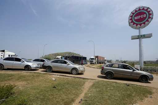 Cars and trucks wait to buy Compressed Natural Gas…