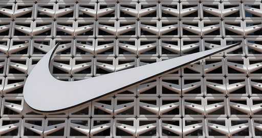 File - The Nike logo is shown on a store in Miami Beach, Fla