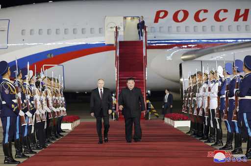 Russian President Vladimir Putin, right, and North Korea's leader Kim Jong Un shake hands during th…