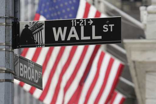 Signs marking the intersection of Broad and Walls streets appear near the New York Stock Exchange, …