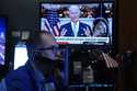 President Jose Biden appears on a screen as trader Mark Puetzer works on the floor of the New York …