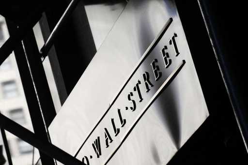 This July 15, 2013, file photo, shows a sign for Wall Street outside the New York Stock Exchange