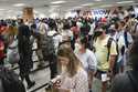 Travelers line up for security clearance at Hartsfield-Jackson Atlanta International Airport on Fri…