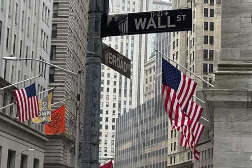 American flags hang from the front the New York Stock Exchange, right, on April 11, 2024, in New Yo…