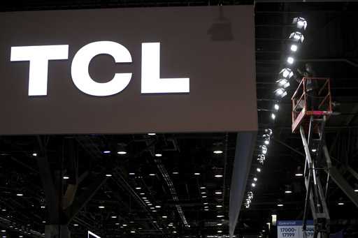 FILE -TCL logo is seen as workers prepare a booth during setup for the CES tech show January 4, 202…