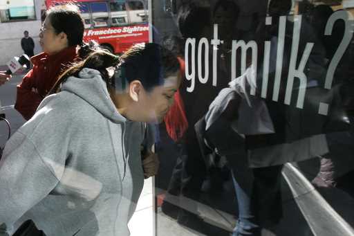 Ihrene Supapo smells the aroma around the new scented "Got Milk?" advertisement in San Francisco, M…