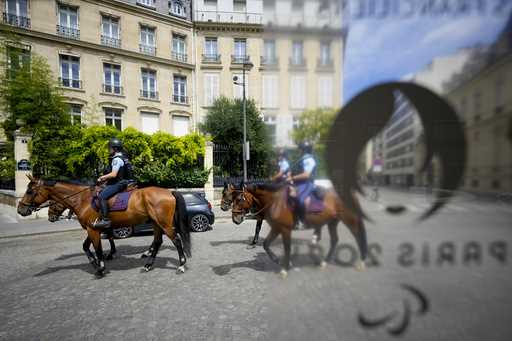 Police officers on horses patrol the streets at the 2024 Summer Olympics, Thursday, July 25, 2024, …