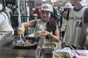 Students from Food and Finance high school make taco dough during a summer block party outside the …