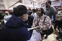 A woman reacts as she receives a check at the gymnasium of Pasadena City College where The Change R…