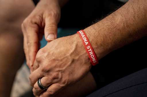 Kawehi Akiona wears a wristband with the words "Lahaina Strong" at his home, Thursday, December 12,…