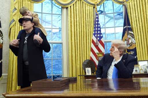 President Donald Trump listens as Elon Musk, joined by his son X Æ A-Xii, speaks in the Oval Office…