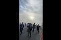 In this image taken from video provided by Justus Rainey, passengers move away from a plane as smok…