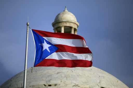 The Puerto Rican flag flies in front of the Capitol building in San Juan, Puerto Rico, July 29, 201…