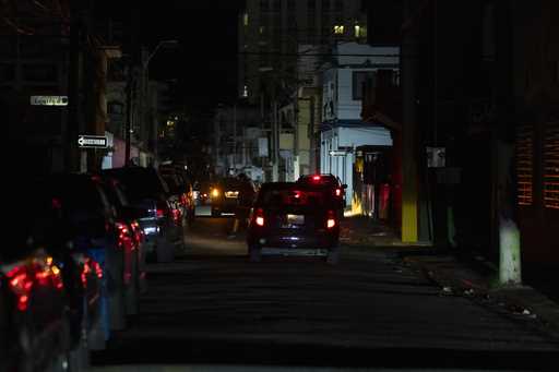 A street is dark during a blackout in San Juan, Puerto Rico, after sunset on Tuesday, December 31, …