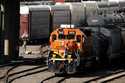 A worker boards a locomotive at a BNSF rail yard, Sept