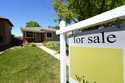 A for sale sign stands outside a single-family residence on the market Wednesday, May 22, 2024, in …