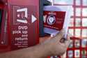 A rental DVD is dispensed from a Redbox at a 7-Eleven in Los Angeles on August 7, 2009