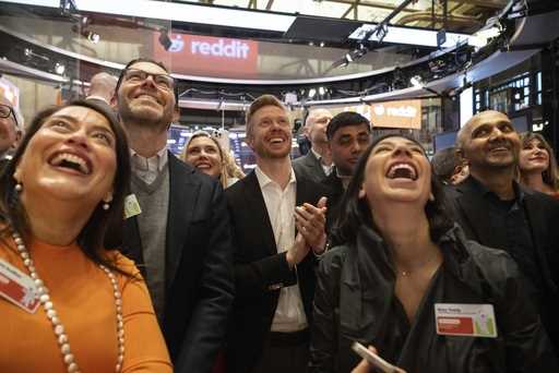 Reddit CEO Steve Huffman and company employees celebrate on the New York Stock Exchange trading flo…