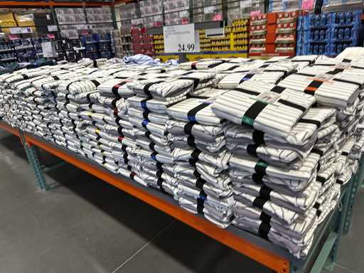 A table is stacked with striped lounge sets in a Costco warehouse Monday, February 3, 2025, in east…