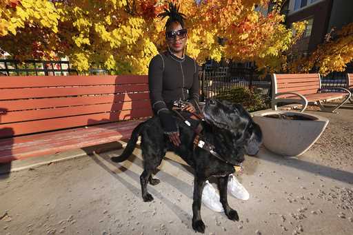 Amber Sherrard and her 10-year-old black Labrador Della are shown outside their home Friday, Novemb…