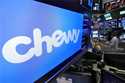 The logo for Chewy appears above trading posts on the floor of the New York Stock Exchange, June 14…