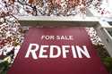 A Redfin "for sale" sign stands in front of a house on October 28, 2020, in Seattle