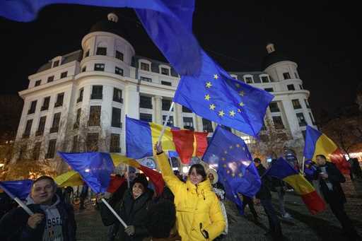 People wave Romanian and European Union flags during a pro-European rally ahead of the country's De…