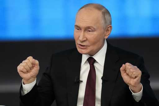 Russian President Vladimir Putin gestures while speaking during his annual news conference and call…