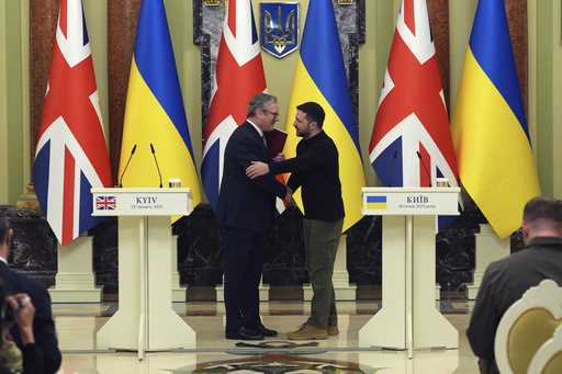 British Prime Minister Keir Starmer, left and Ukrainian President Volodymyr Zelenskyy shake hands, …