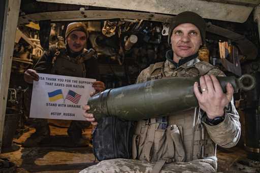 Soldiers of Ukraine's 5th brigade hold a poster thanking for the US for support during a flashmob a…