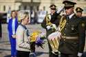 President of the European Commission Ursula von der Leyen, left, holds a bouquet of flowers to plac…