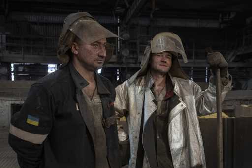 Steel melting workers chat at work at the Zaporizhstal Iron and Steelworks, one of the country's la…