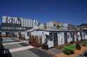 A person walks under a Mission Cabins sign at the Five Keys transitional housing location in San Fr…