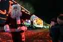 Santa Claus waves to children during a visit of the CSX Holiday Express Thursday, November 21, 2024…