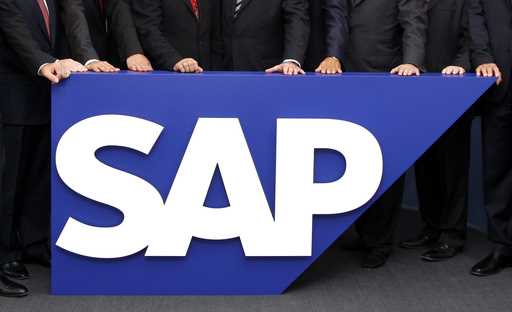 The board members of German software company SAP stand behind the company logo at its headquarters …