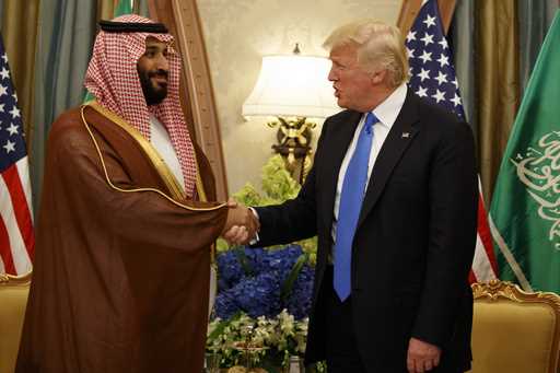 FILE- President Donald Trump shakes hands with Saudi Deputy Crown Prince and Defense Minister Moham…