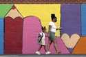 Bria Gibbs brings her daughter Tai'la Harris, 4, into Columbia Elementary school for the first day …