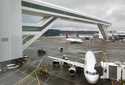 Planes taxi under the aerial passenger walkway at Seattle-Tacoma International Airport, March 3, 20…