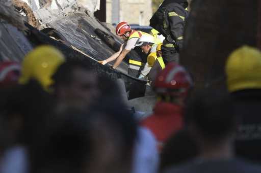 Rescue workers search for victims in the aftermath of an outdoor roof collapse at a train station i…