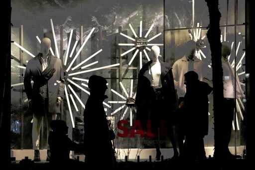 Shoppers walk on the Michigan Avenue in downtown Chicago, December 15, 2024