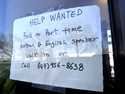 A hiring sign is displayed at a restaurant in Mount Prospect, Ill